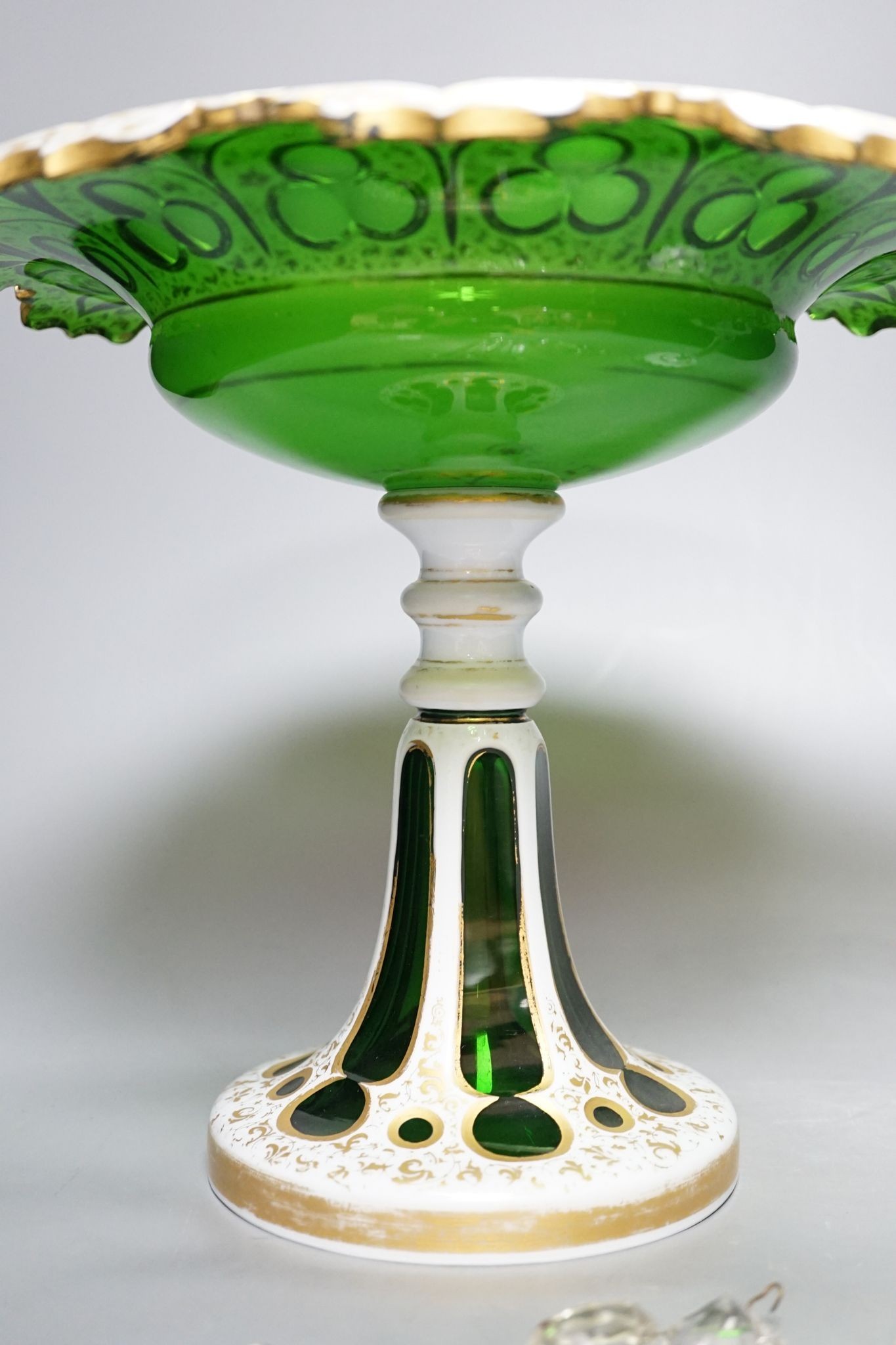 A 19th century overlaid green glass comport, 24cm high, and a similar table lustre